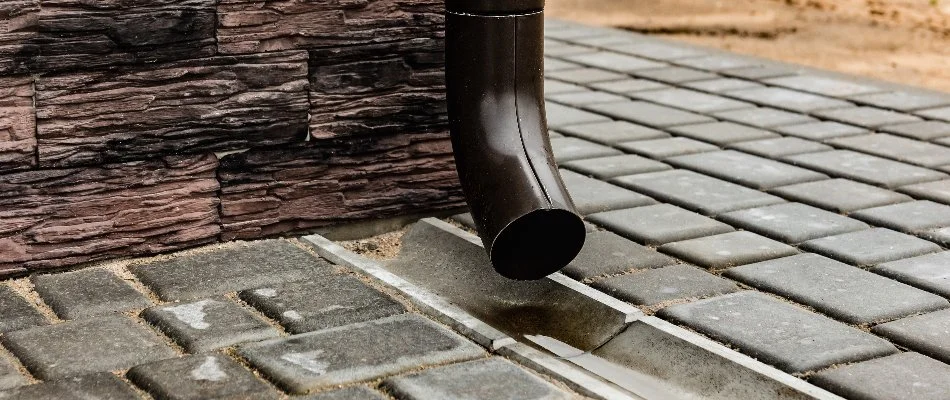 Downspout above a paved ground in Bristow, VA.