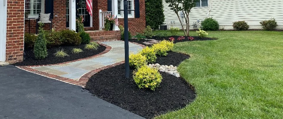 Manicured green lawn and neat, mulched landscape bed in Bristow, VA.