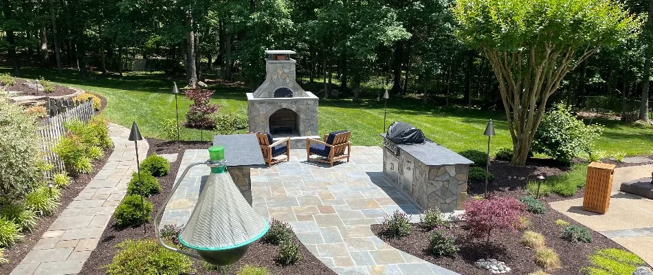 Outdoor fireplace on a patio in Bristow, VA, with a kitchen.