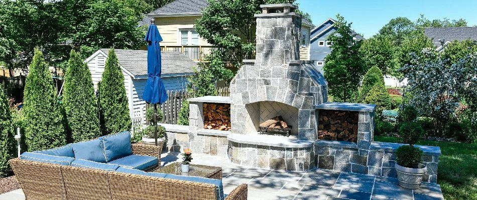 Outdoor fireplace with blue seating in Bristow, VA.
