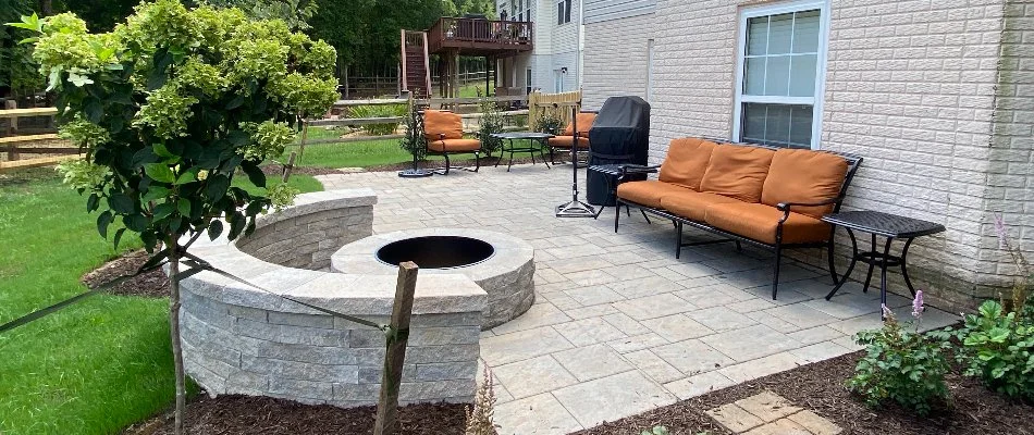 Round fire pit in Bristow, VA, with a seating wall.
