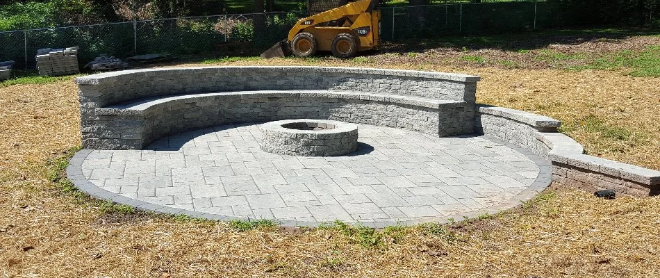 Seating wall on a patio in Bristow, VA, with a fire pit.